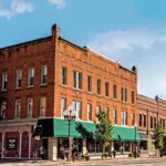 The exterior of a brick historic commercial building with lots of windows