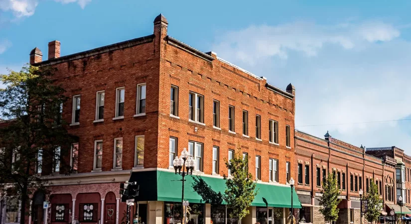 The exterior of a brick historic commercial building with lots of windows