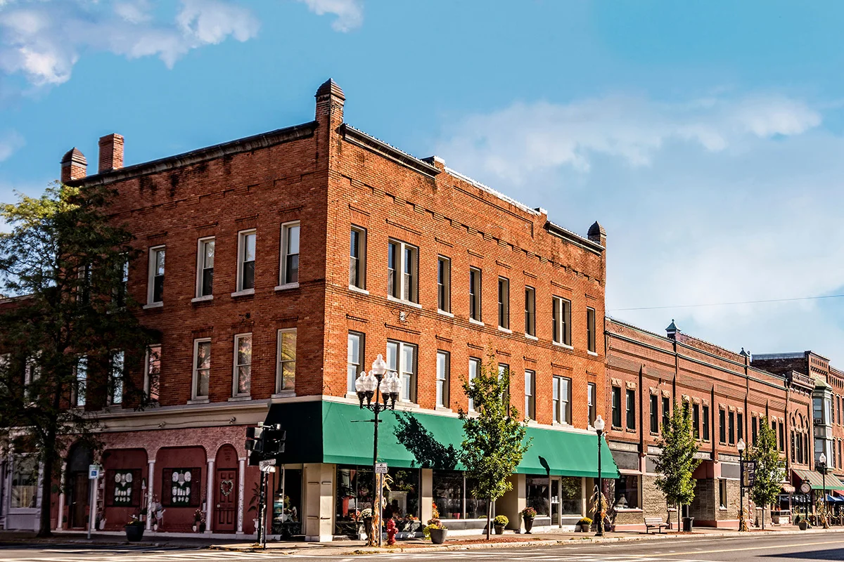 The exterior of a brick historic commercial building with lots of windows